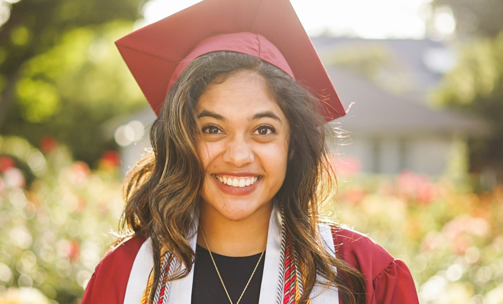 Smiling graduate staring at camera